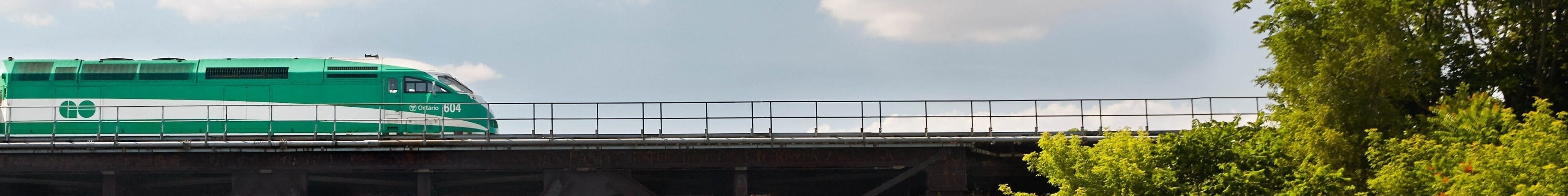 kayaker approaching GO Train bridge