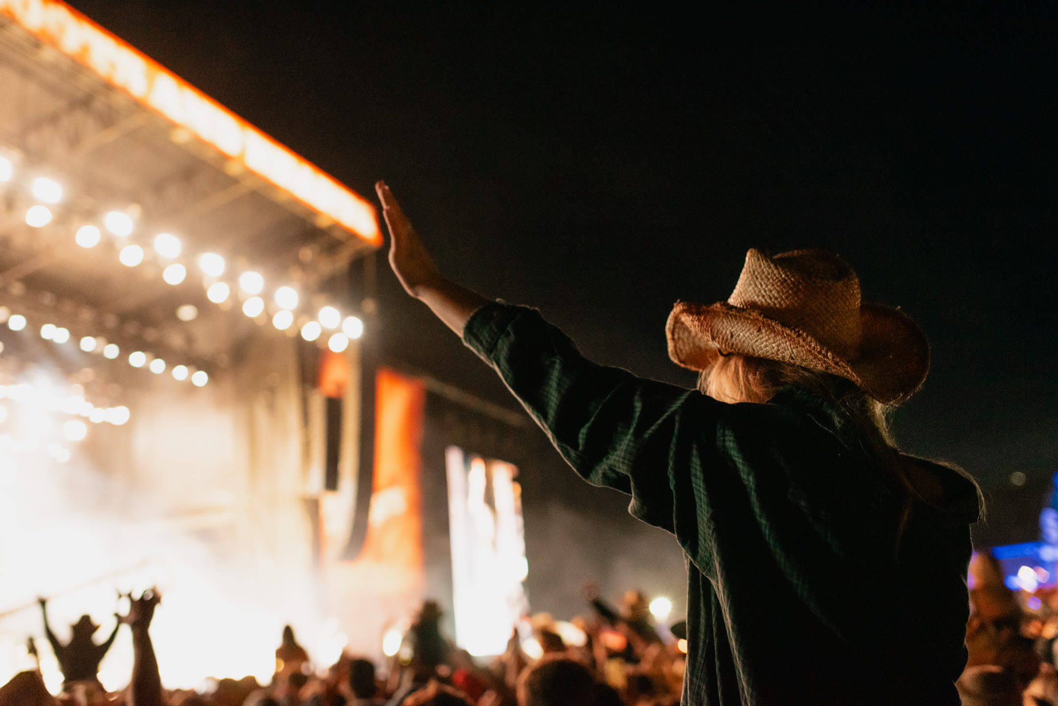 Boots and hearts lady waving at stage