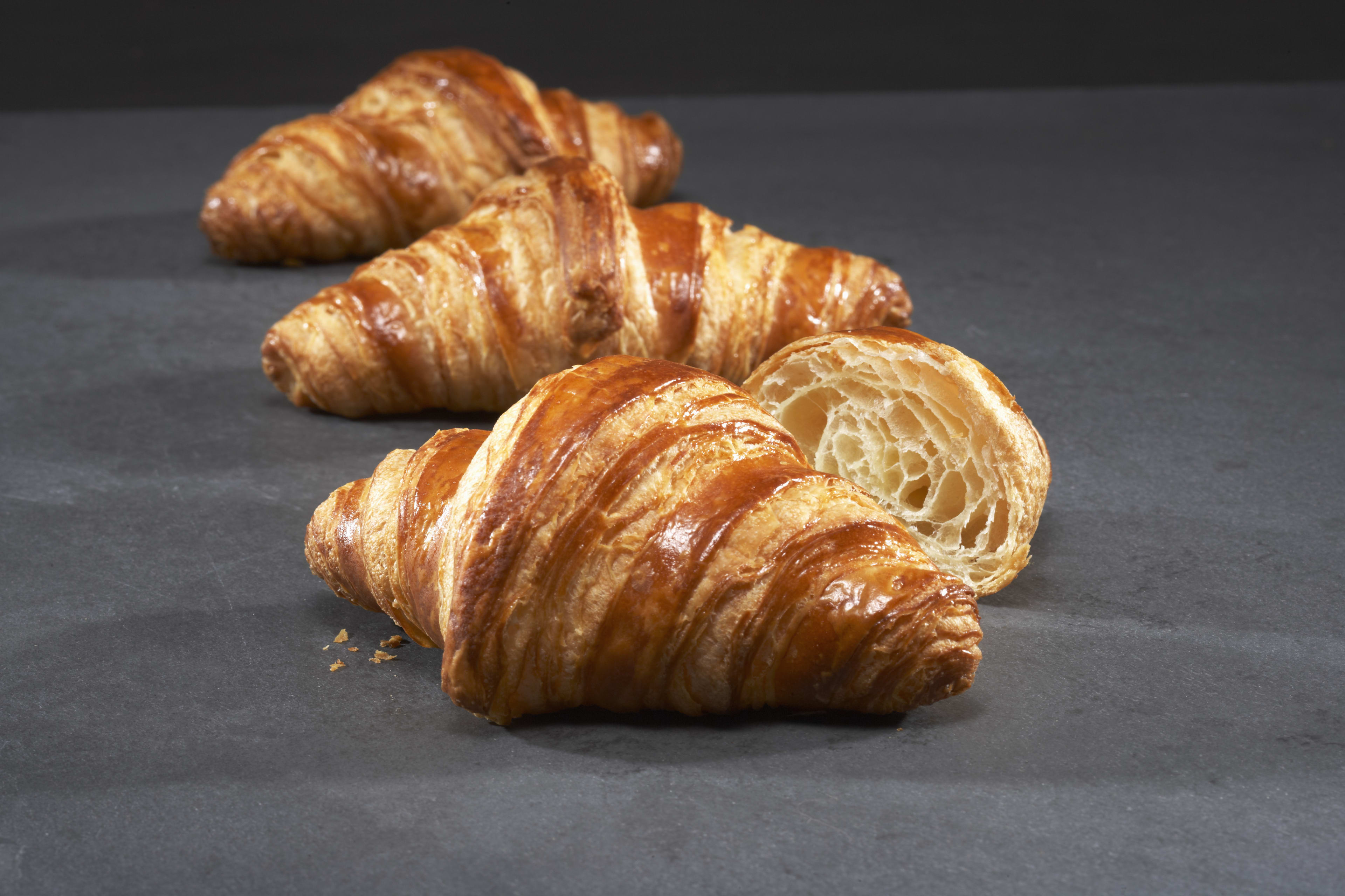 Three flaky butter croissants from Au Pain Doré bakery in Toronto.
