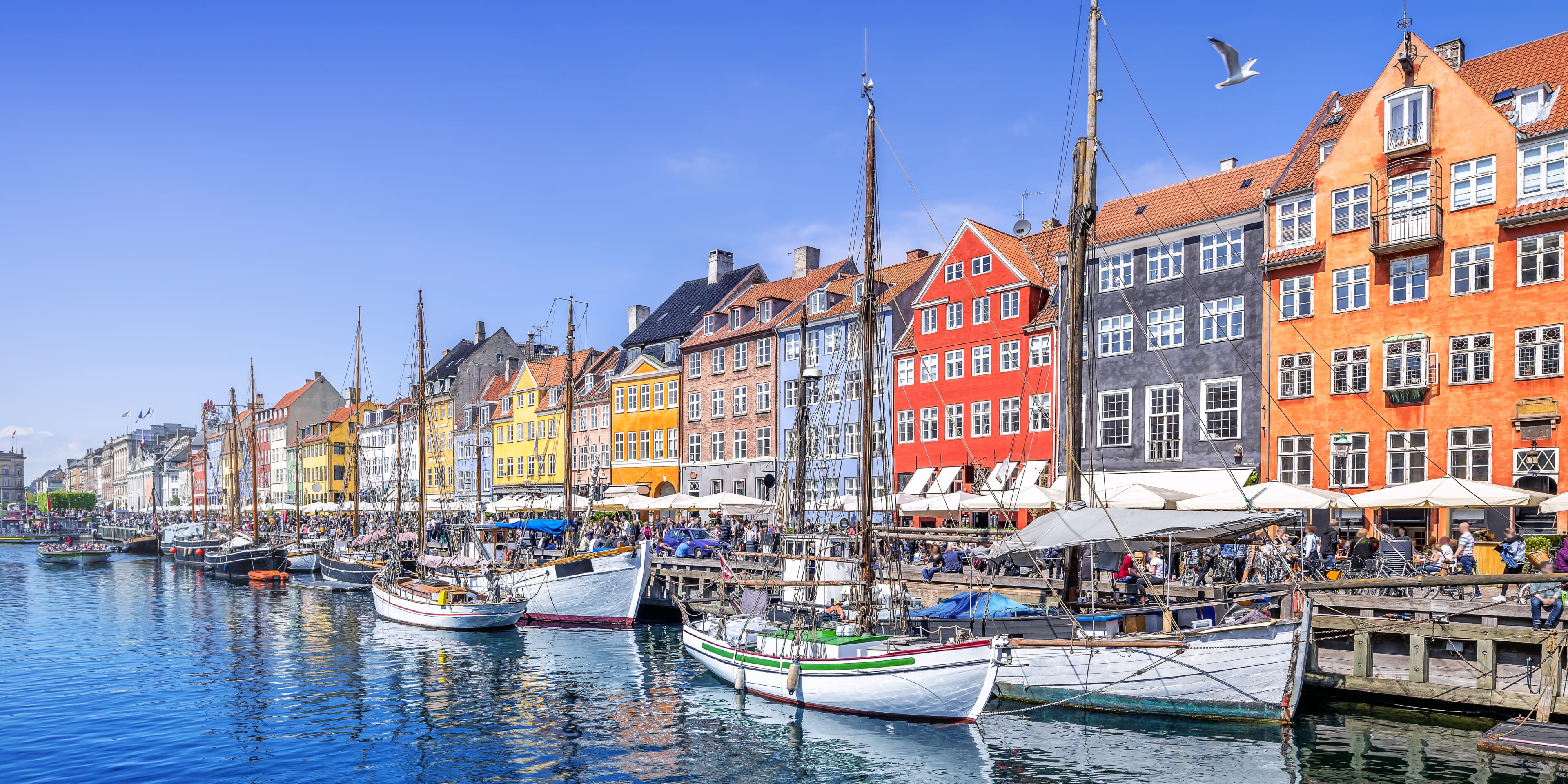 Nyhavn canal lined with colourful houses and boats in the water in Copenhagen, Denmark.