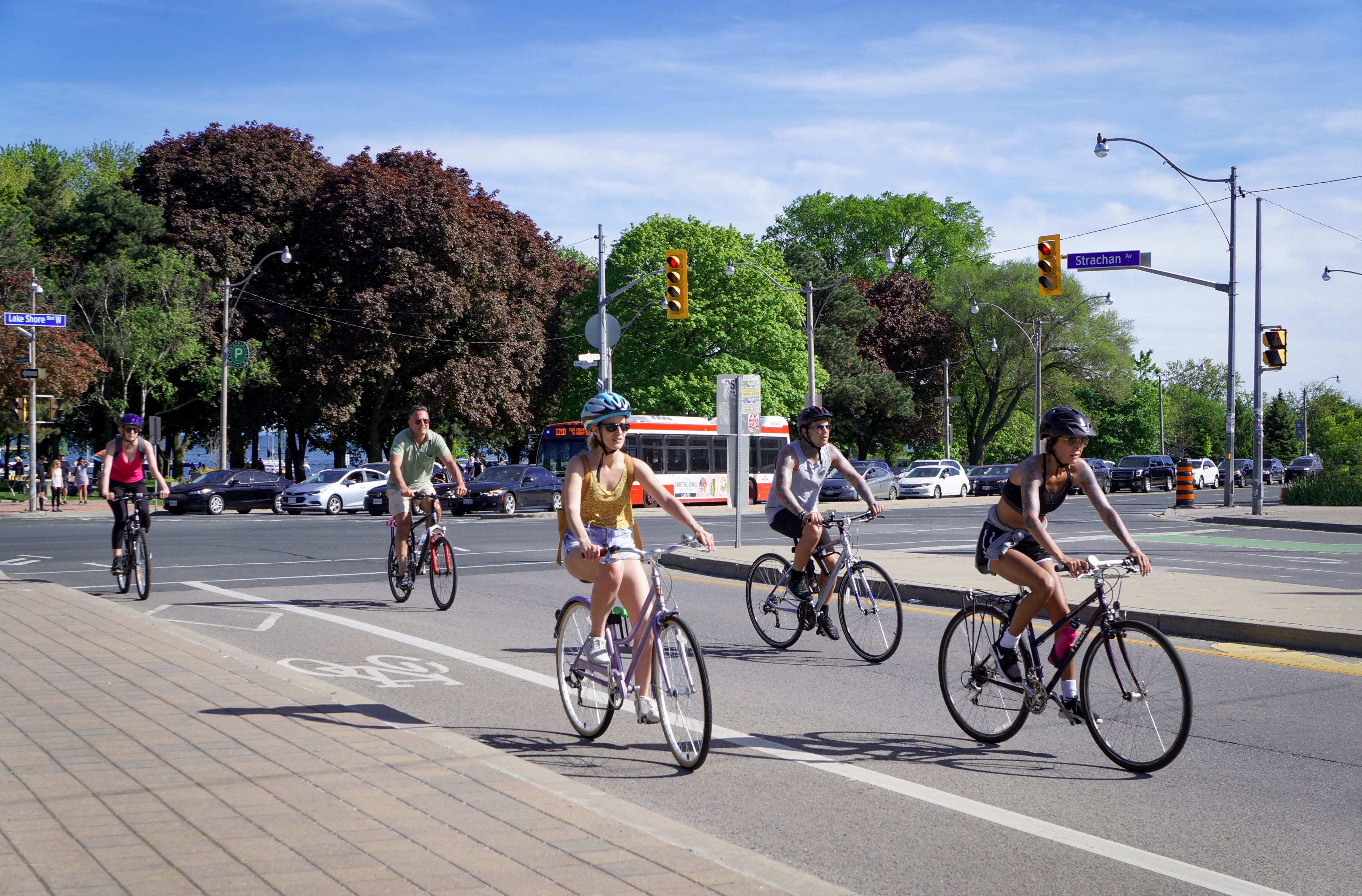 Group of five people biking down road