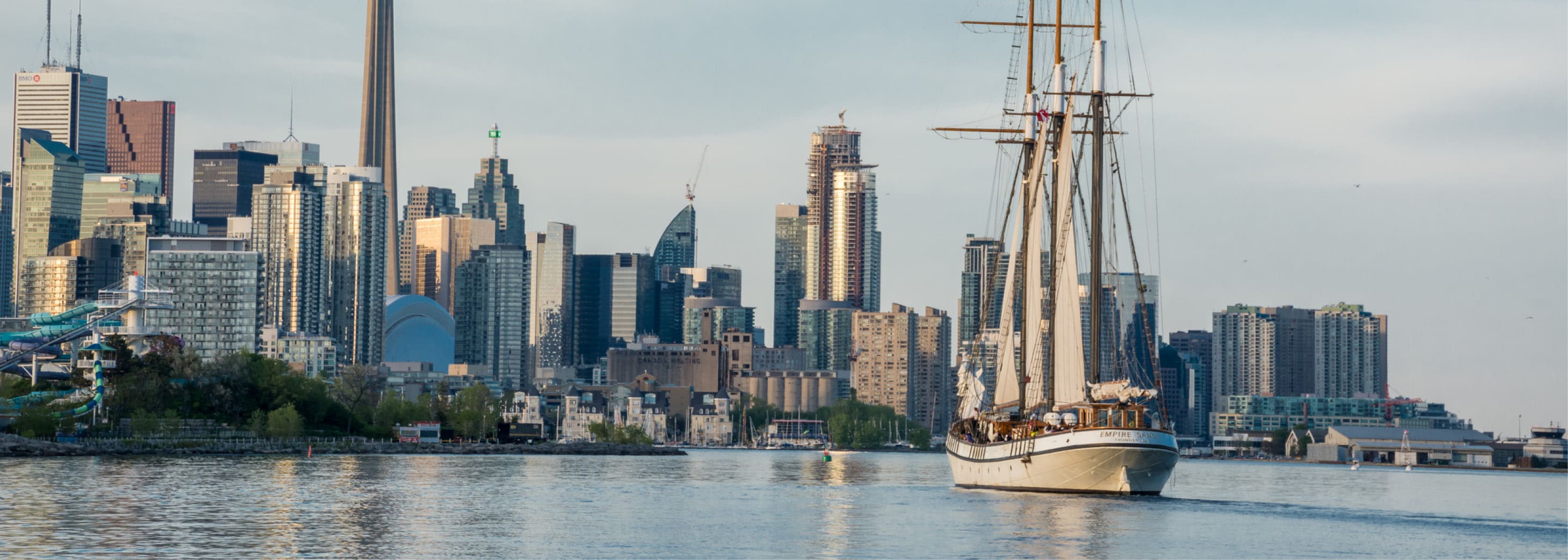 Lake Ontario with city scape behind and large boat cruising through the water