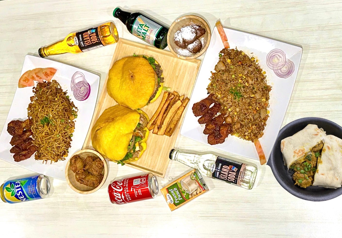 Spread of chicken fried rice, drinks and more Caribbean dishes from Riko Bokito in Toronto.