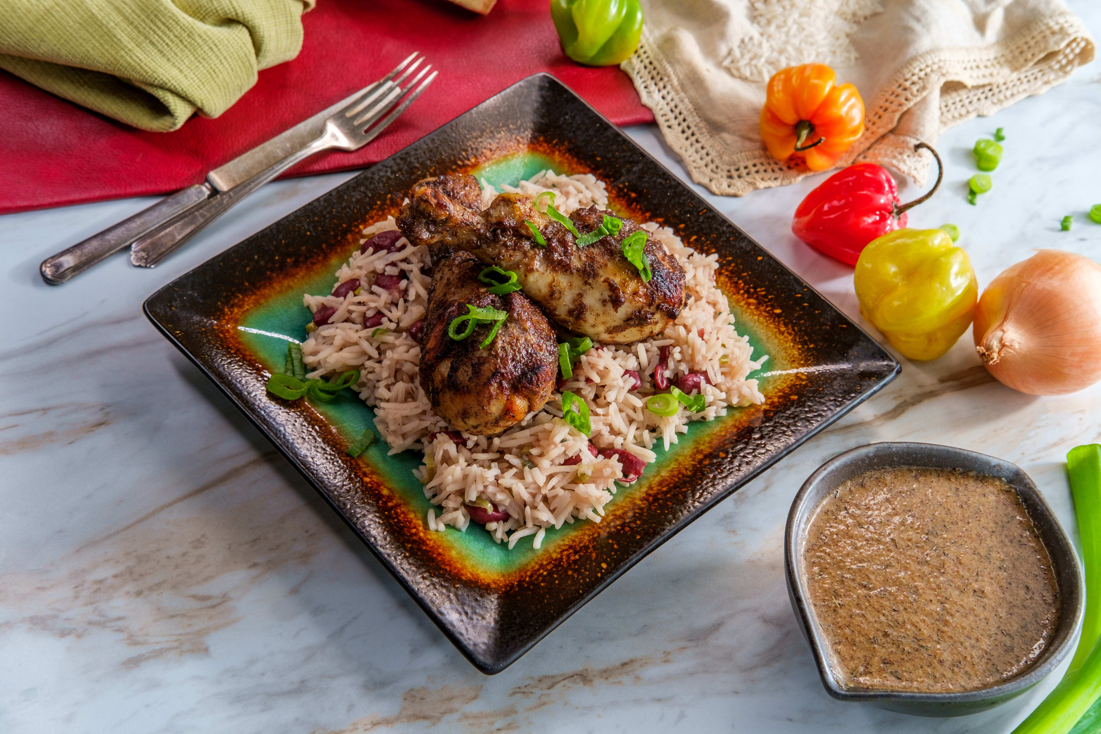 Plate of spicy Jamaican jerk chick legs on rice