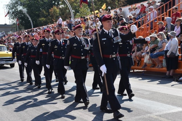 Group of people marching in Warriors' Day Parade at the CNE.