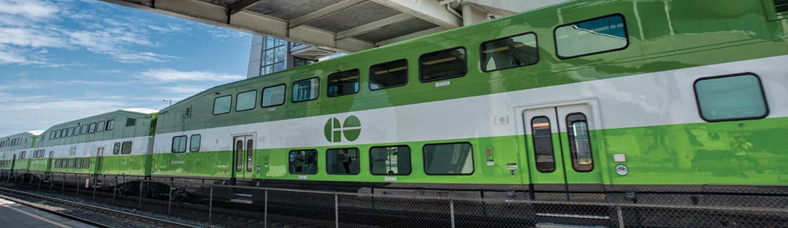 GO Train under a bridge.