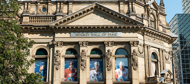 Outside of Hockey Hall of Fame during the day with tree on the right