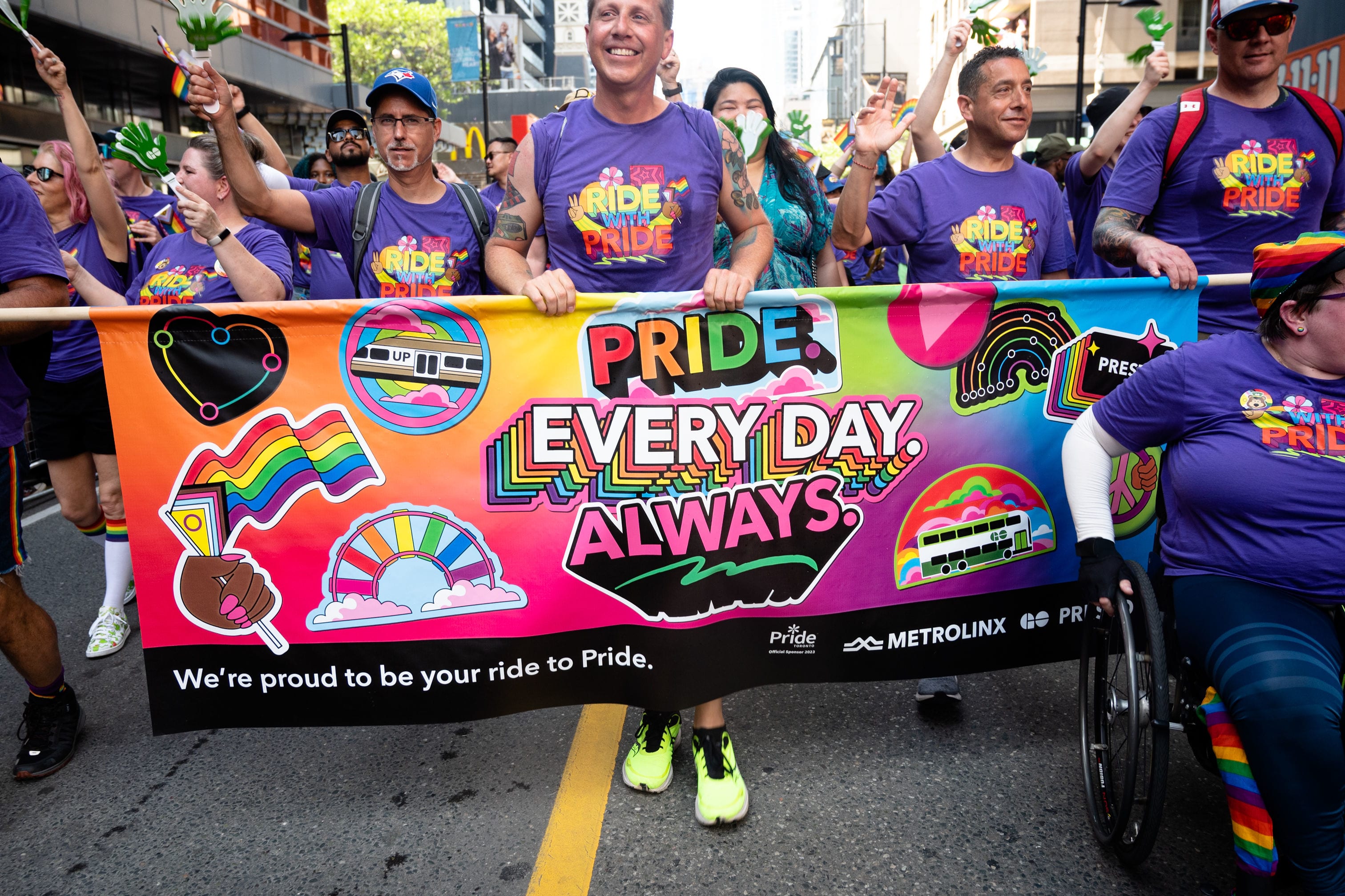"Pride. Everyday. Always." Metrolinx banner being held at Toronto Pride Parade.