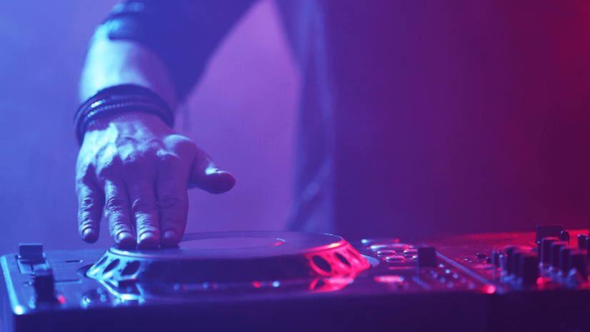 DJ at music festival turning turntable