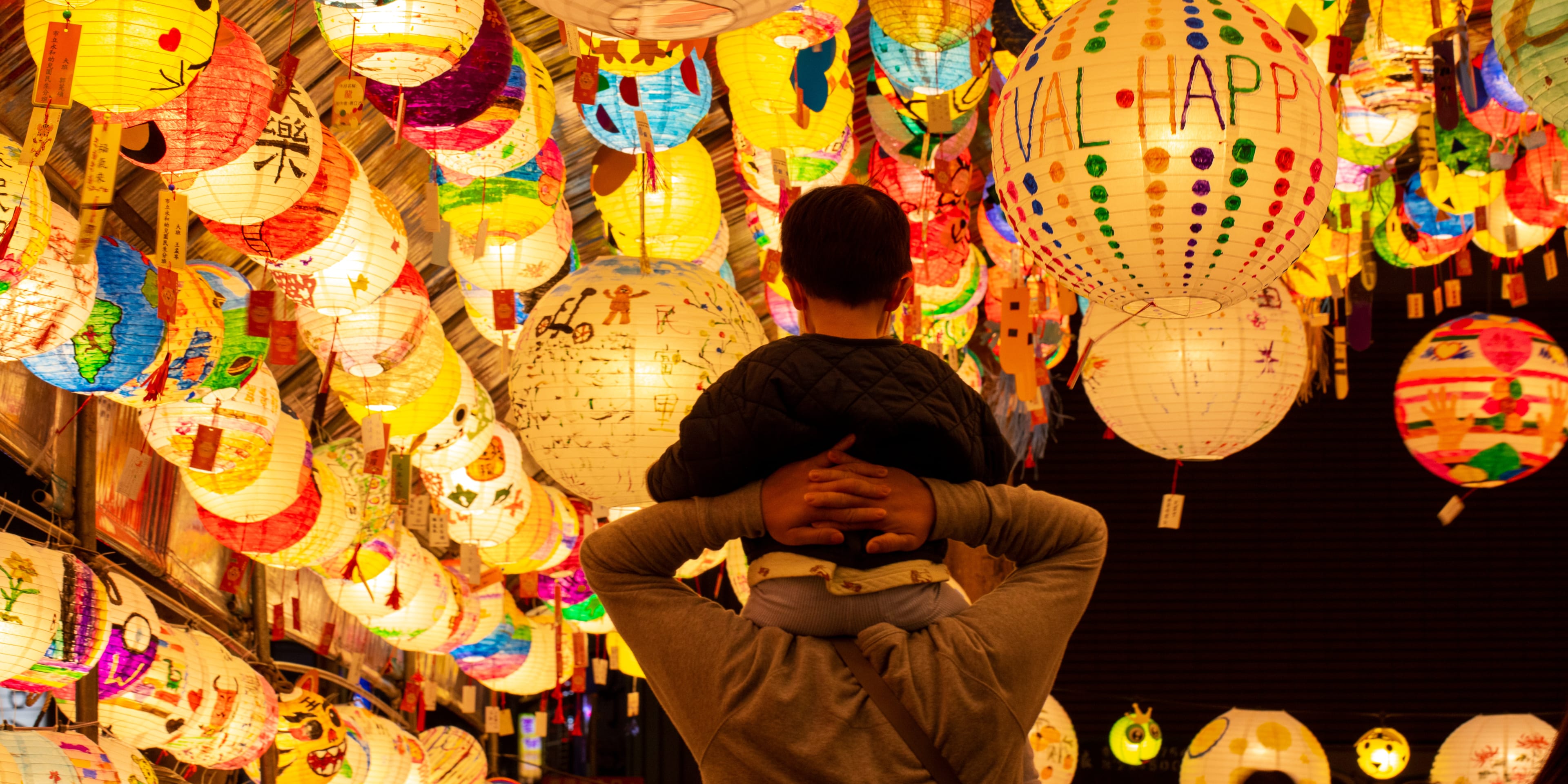Child on shoulders of an adult at Lantern Festival
