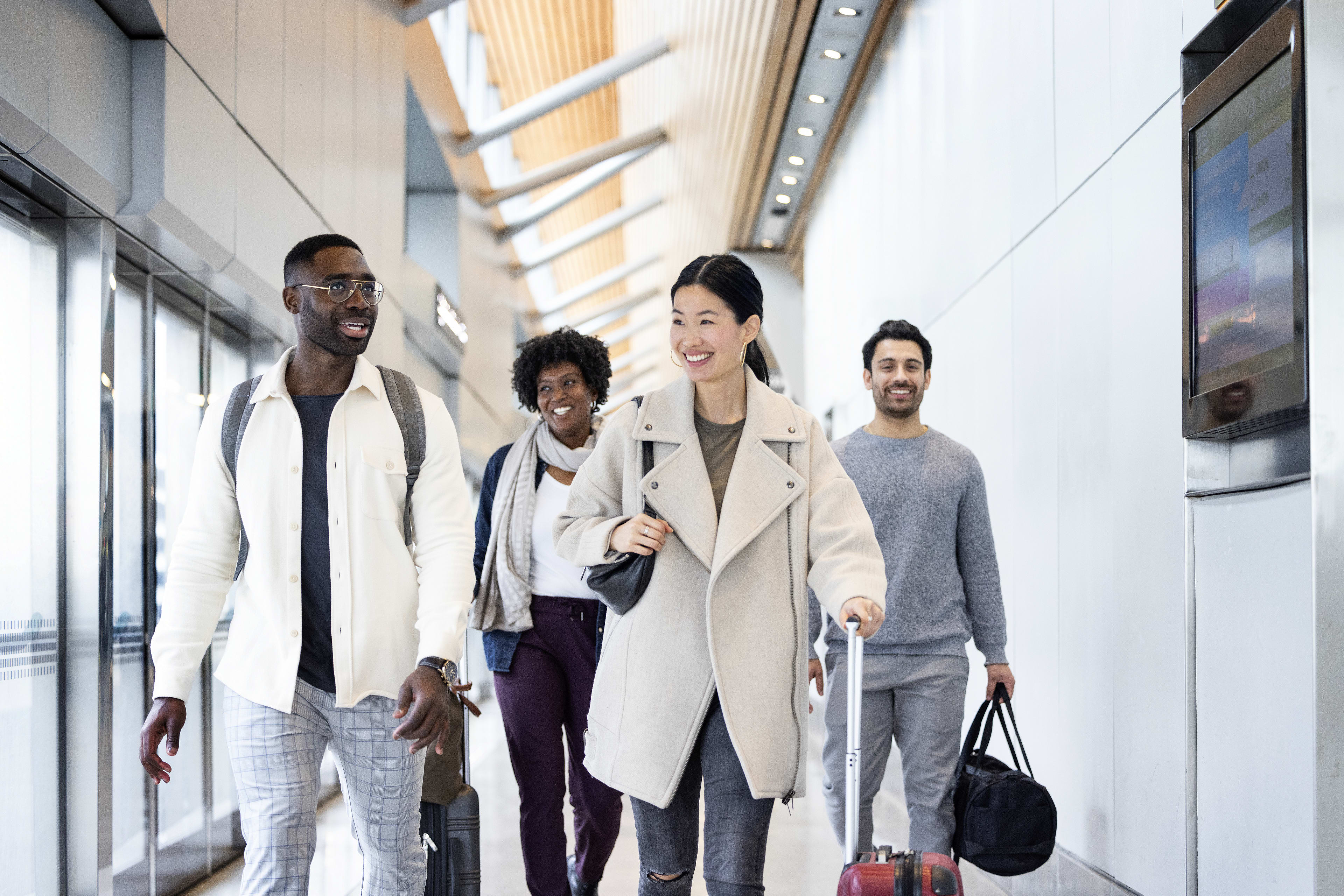 Four people walking down UP Pearson Station platform