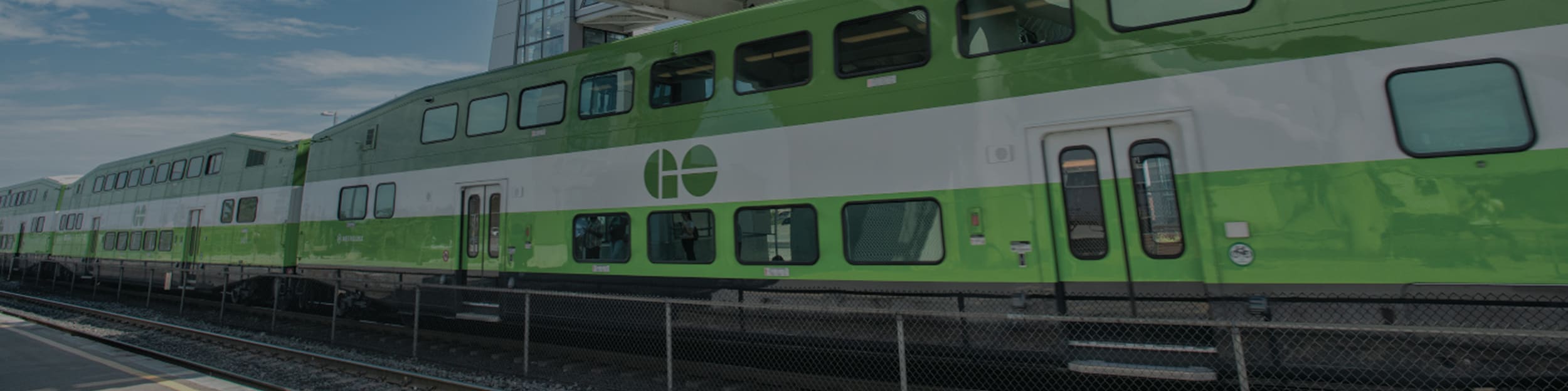 GO Train under a bridge.