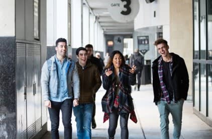 Group of four youth walk down Bay Street, adjacent to Scotiabank Arena