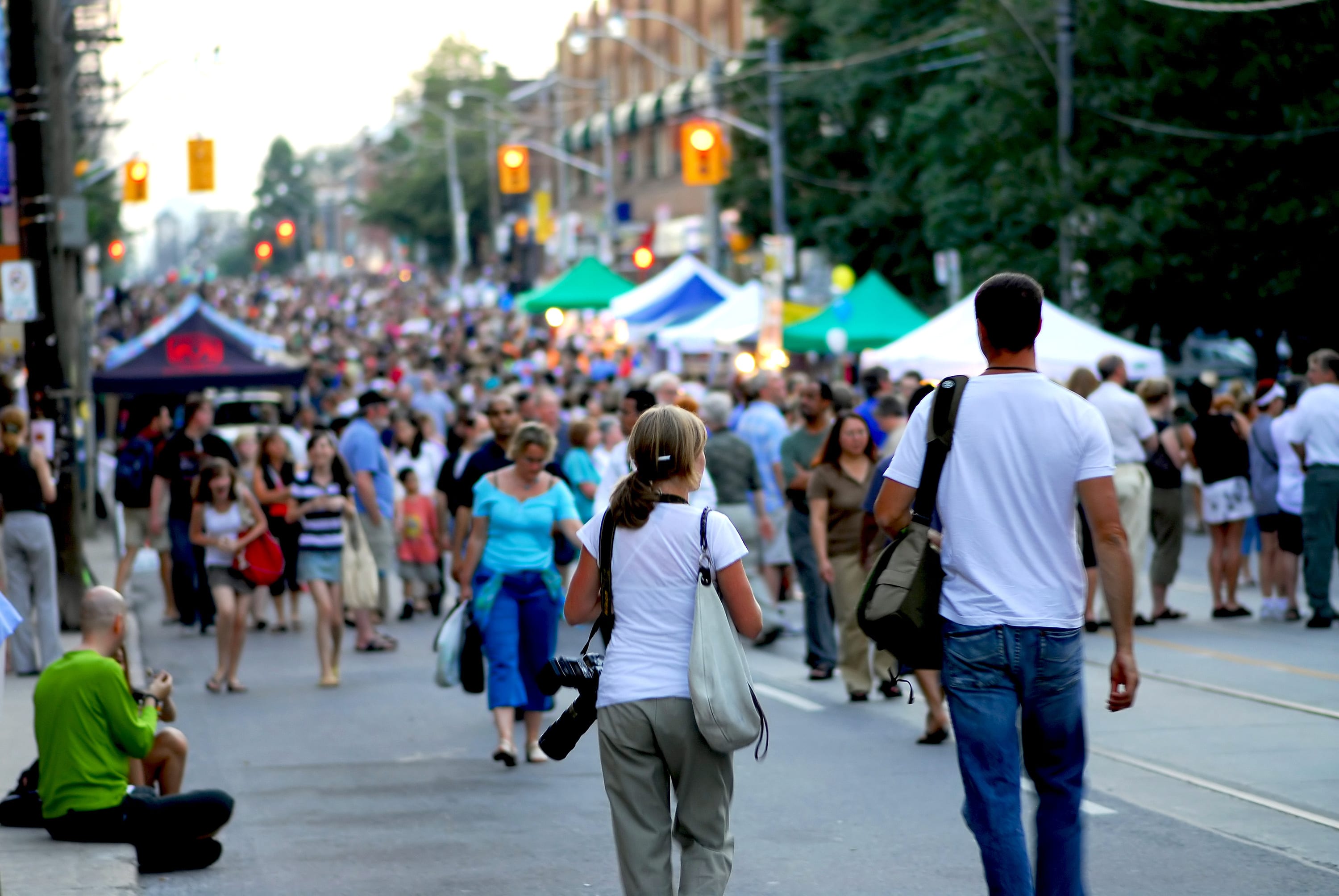 Street in Toronto closed for an outdoor street festival with crowds and tents.