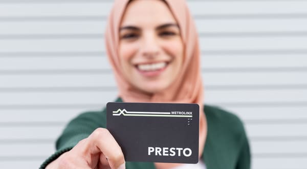 Woman holding a PRESTO card