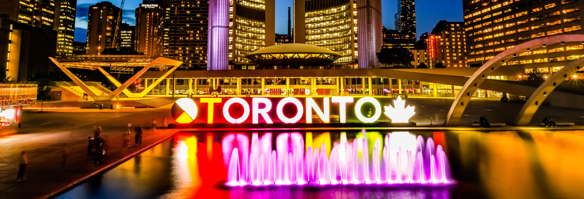 Toronto City Hall at night with sign lit up
