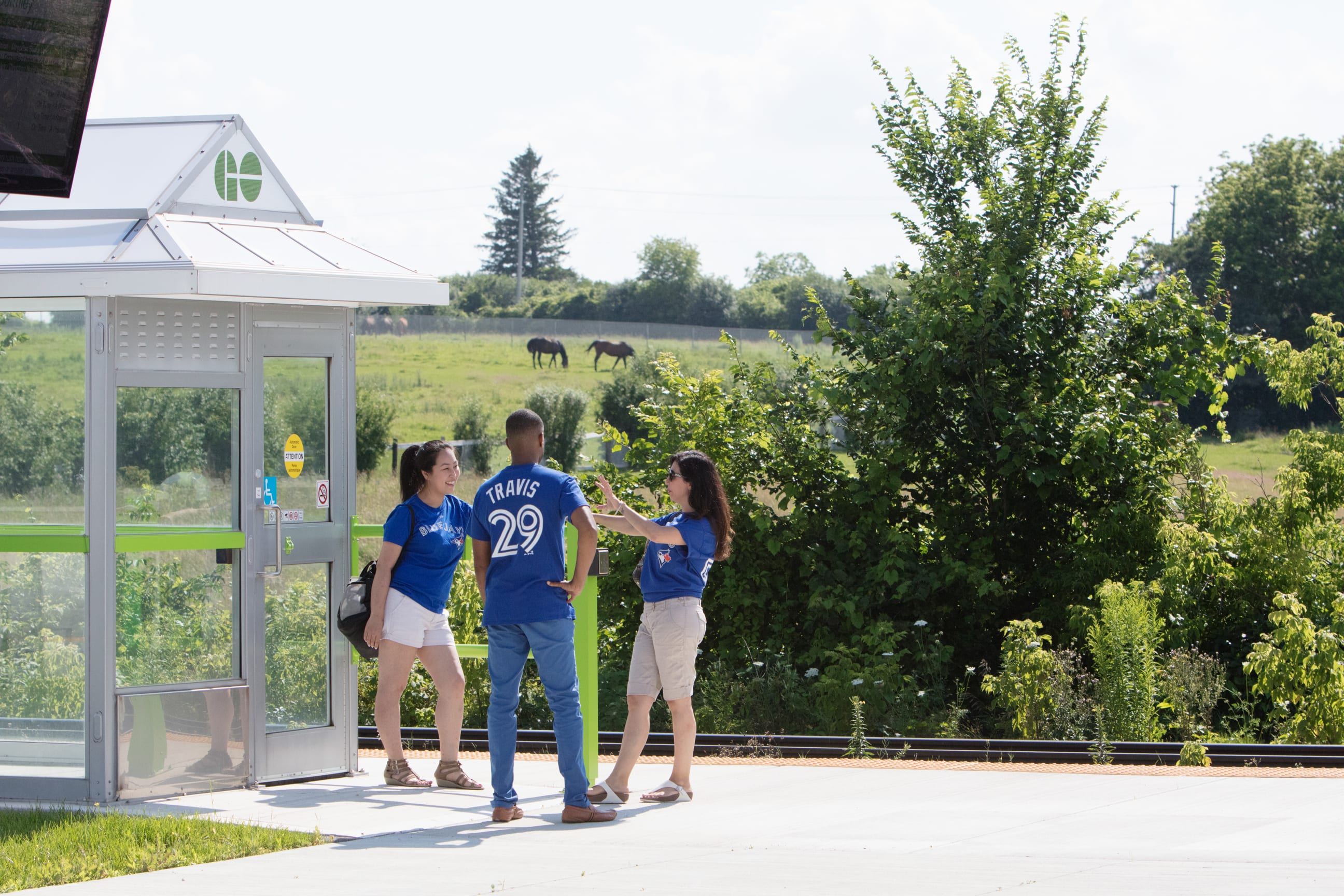 Blue Jays fans and GO Transit customers waiting at a GO Station platform