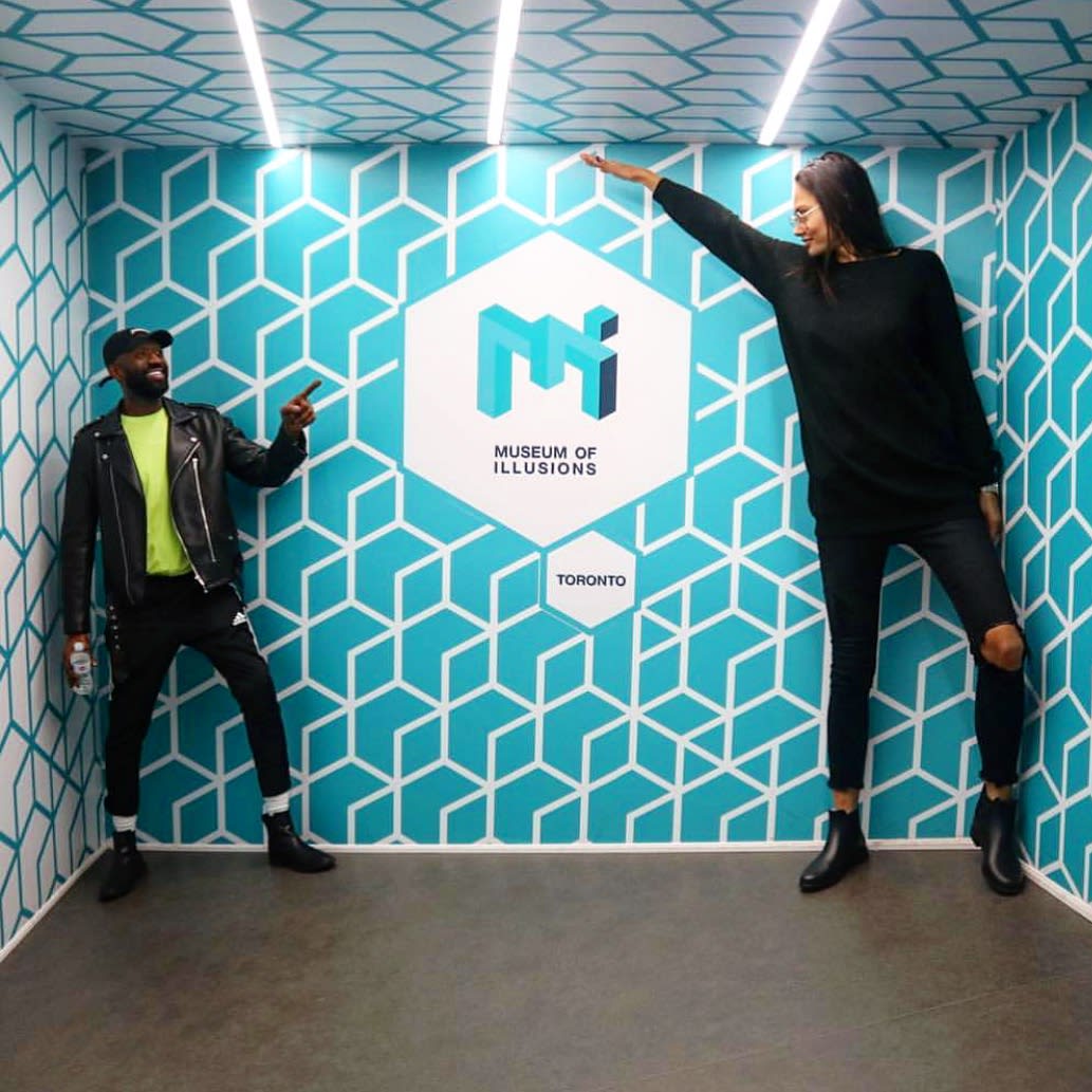 Two people at a Museum of Illusions attraction