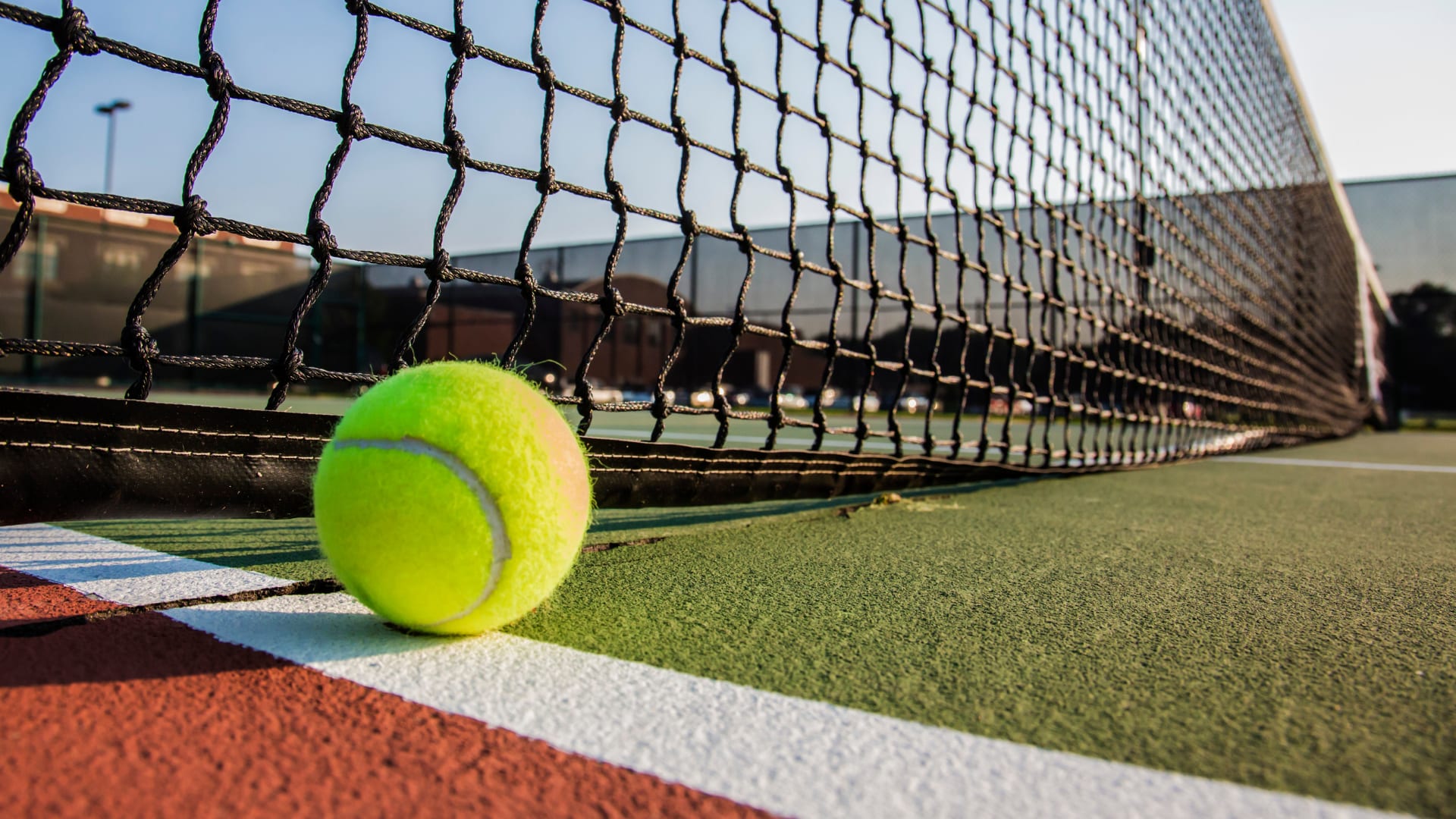 Tennis ball on the ground of an outdoor tennis court