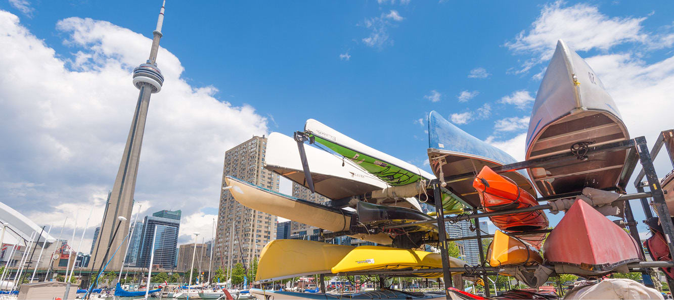 Toronto waterfront featuring a group of kayaks and canoes on a rack